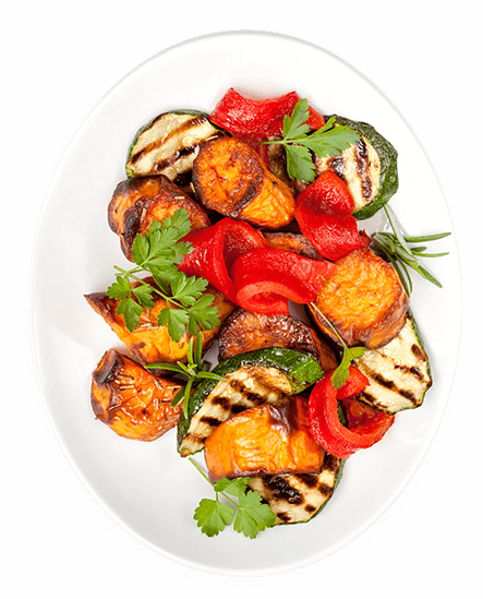 Grilled vegetables on a plate with garnish